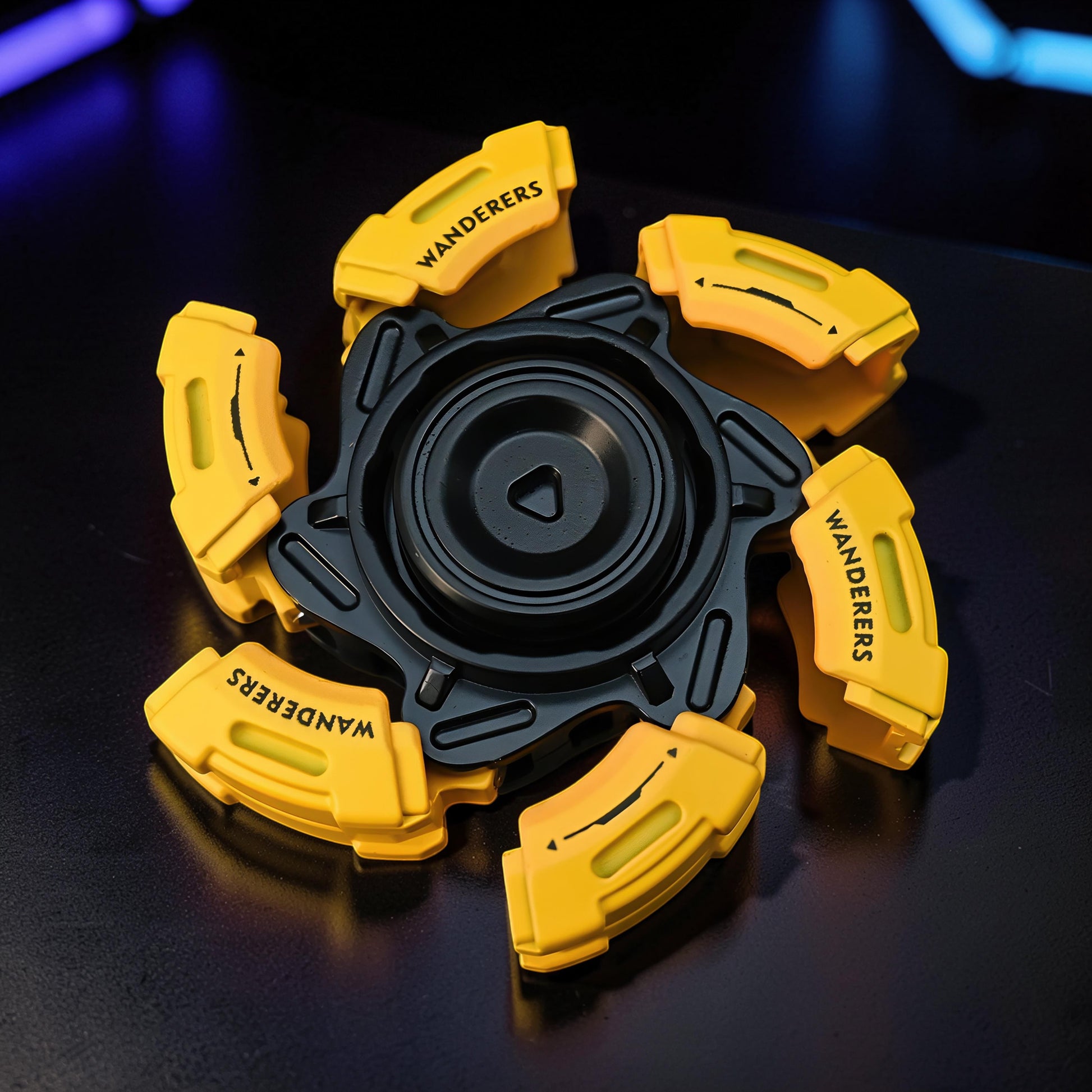 The Curious Mind Bumblebee Metal Spinner in yellow and black, a premium EDC fidget toy with 'WANDERERS' text on each arm.