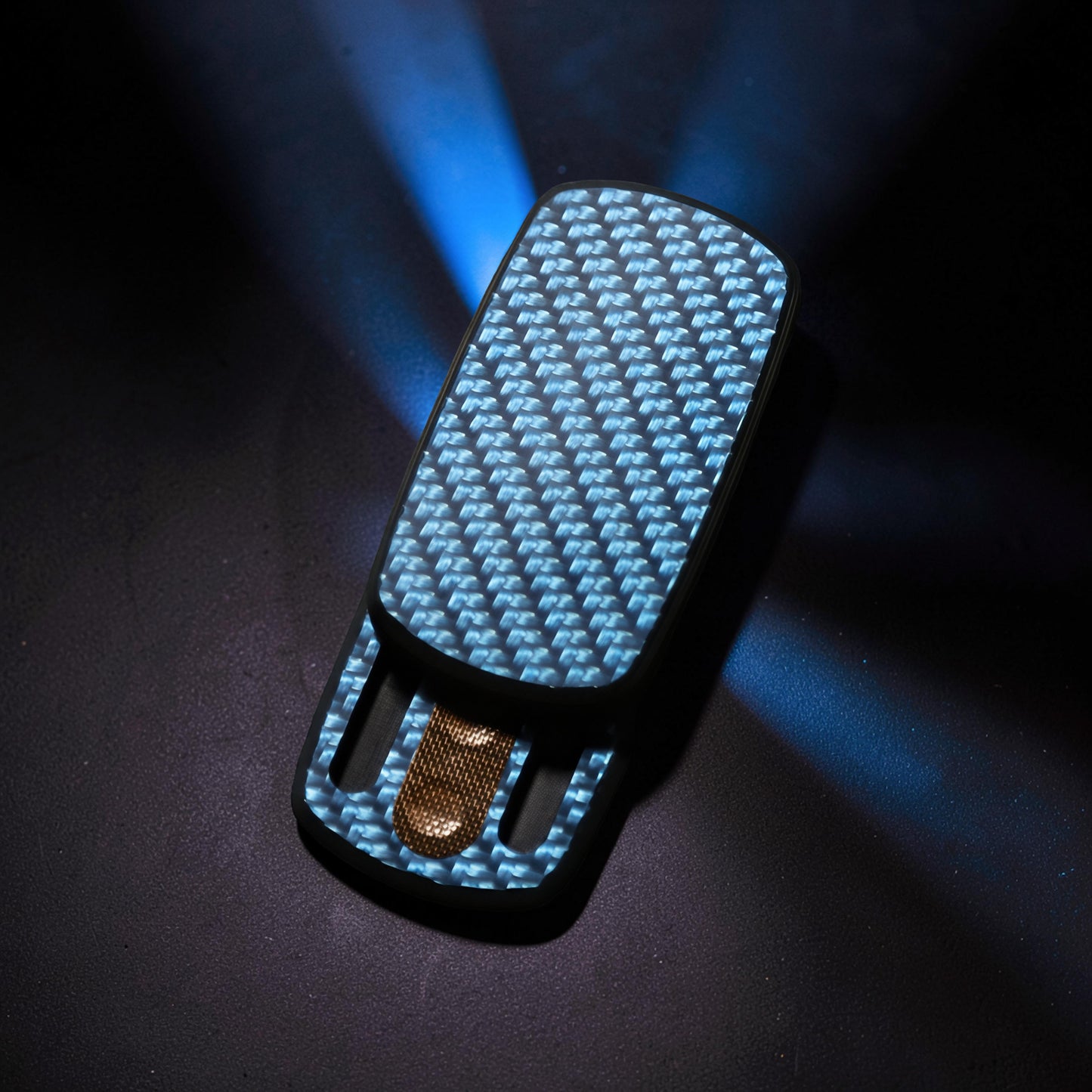 The Curious Mind Carbon Fiber Magnetic Slider fidget toy with blue weave pattern and magnetic push-and-return action.