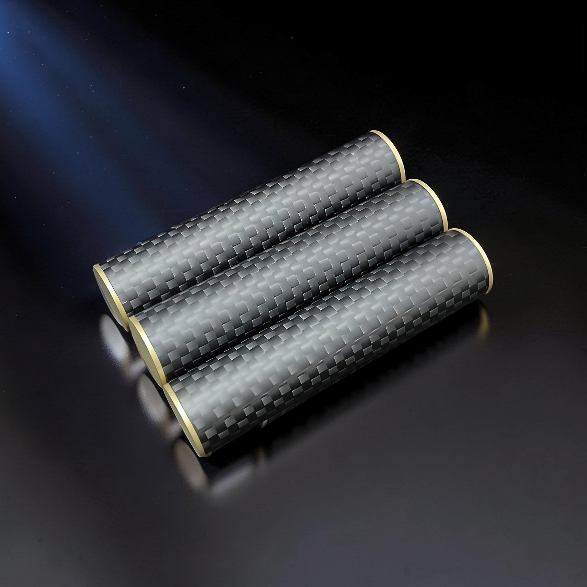 The Curious Mind Magnetic Carbon Fiber Slider with gold accents. Cylindrical fidget toy with a woven carbon fiber pattern.