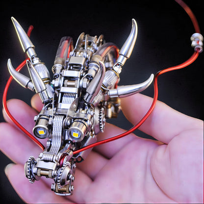 The Curious Mind Chinese Dragon 3D metal model kit, intricate mechanical design with LED eyes and red wire accents, held in a hand.