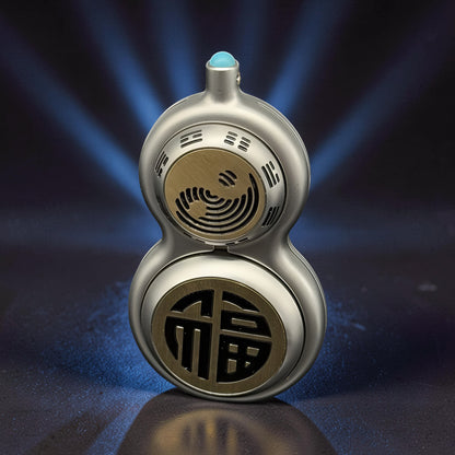 The Curious Mind Cucurbit Gourd Spinner, a silver metal fidget toy with gold accents and a blue gem top. Features Chinese characters and a yin-yang symbol.