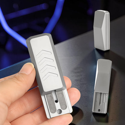 The Curious Mind Cyberpunk Truck Push Slider fidget toy, compact metal design with chevron pattern and tactile grid.