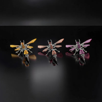 The Curious Mind Cyberpunk Hornet 3D metal model kit in yellow, pink, and purple. Intricate mechanical insect design with metallic wings and segmented bodies.