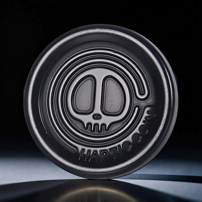 The Curious Mind Demon Coin Push Card Clicker, a compact metal fidget toy with a demon skull design and satisfying click.