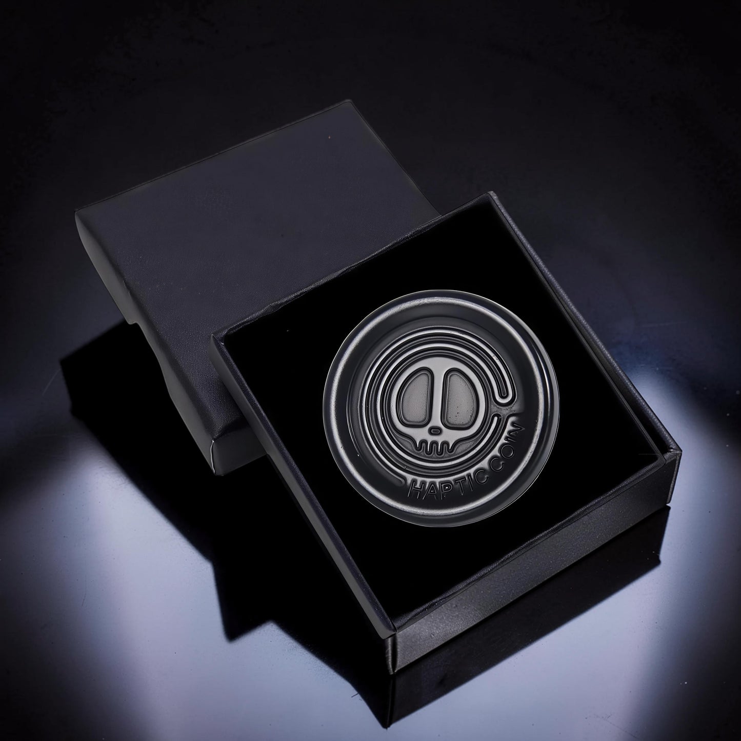 The Curious Mind Demon Coin Push Card Clicker, a compact metal fidget toy with a demon skull design and satisfying click.