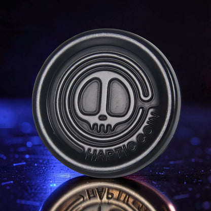 The Curious Mind Demon Coin Push Card Clicker, a compact metal fidget toy with a demon skull design and satisfying click.