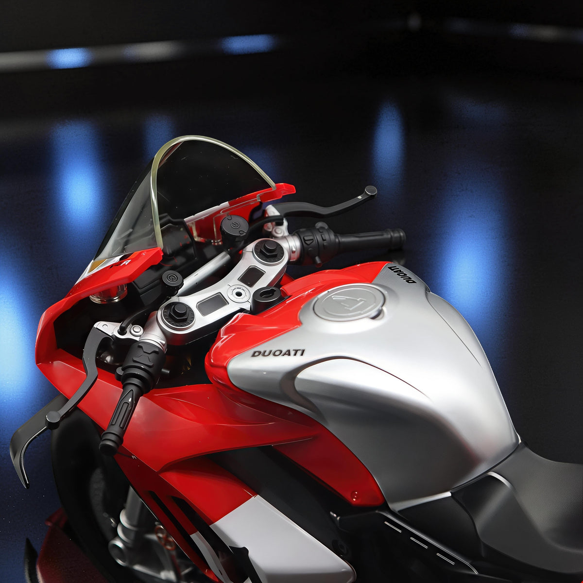 The Curious Mind 1/6 diecast motorcycle model in red and silver, with detailed handlebars and fuel tank.
