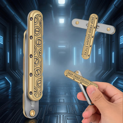 The Curious Mind Deep-Fried Dough Stick magnetic slider fidget toy, gold and silver metal, bar-style design with tactile slider action.