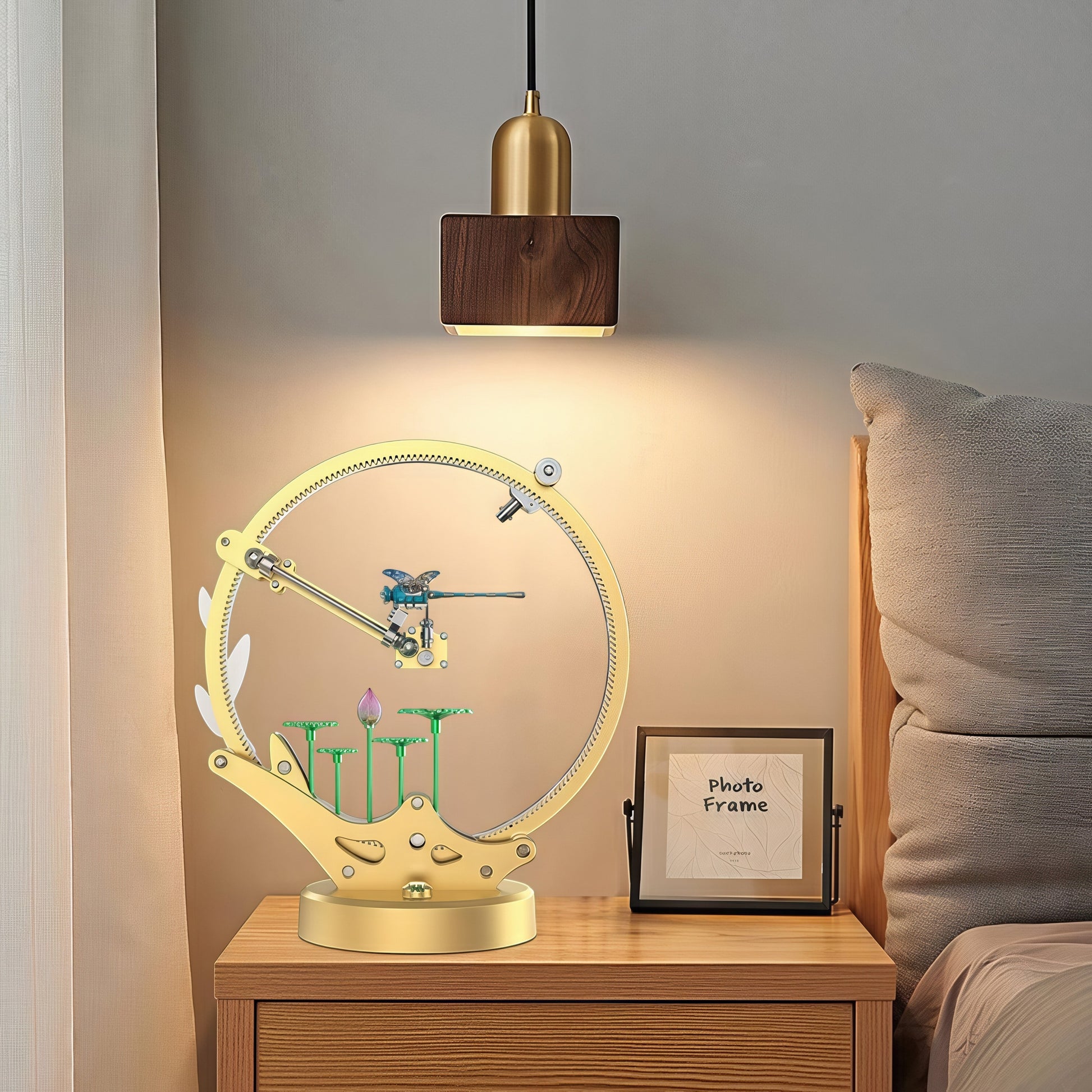 The Curious Mind Flying Dragonfly Kinetic DIY Kit, a mechanical metal model with a golden frame, blue dragonfly, and lotus flowers.