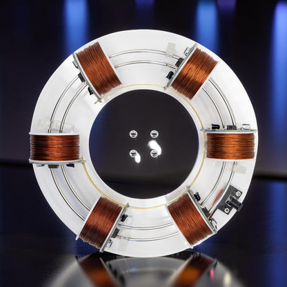 The Curious Mind High-Tech Electromagnetic Coil Accelerator Display, a white circular metal and acrylic science toy with copper coils.