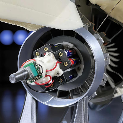The Curious Mind turbofan engine display model, made of white and grey PLA, featuring internal mechanics and batteries.