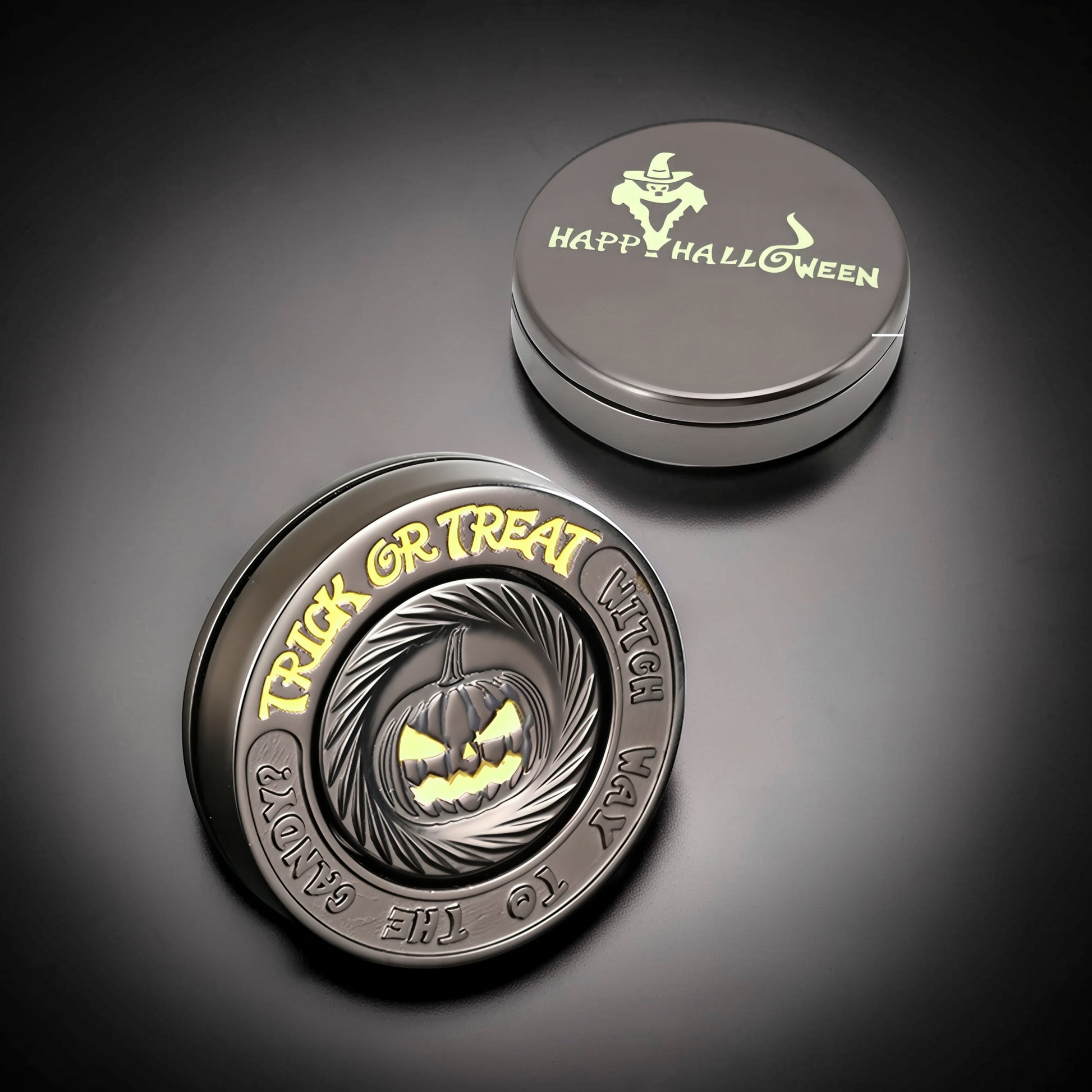 The Curious Mind Evil Pumpkin Haptic Coin Spinner with "Trick or Treat" and a carved pumpkin design. Metal construction.