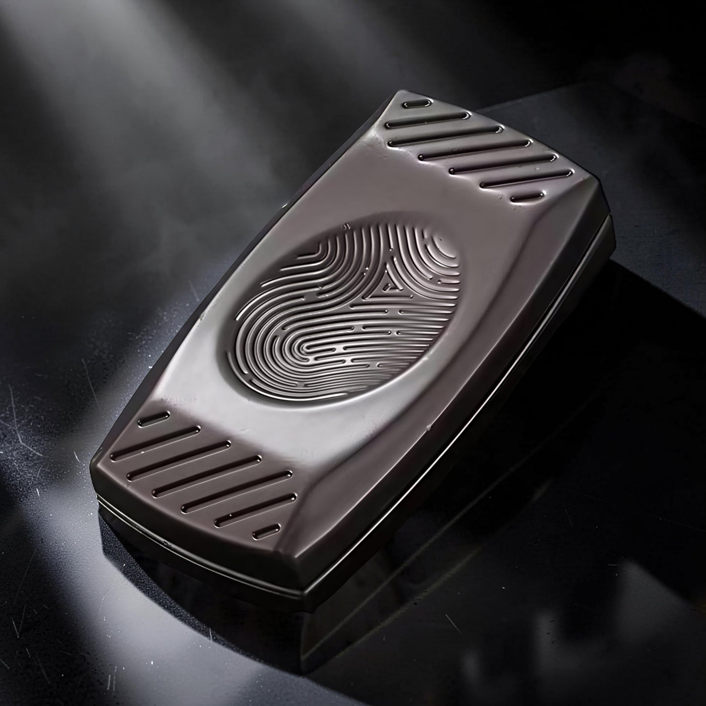 The Curious Mind Fingerprint Pattern Push Slider, a compact metal fidget toy with a fingerprint-inspired design and textured sides.