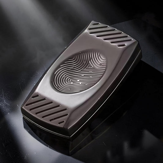 The Curious Mind Fingerprint Pattern Push Slider, a compact metal fidget toy with a fingerprint-inspired design and textured sides.