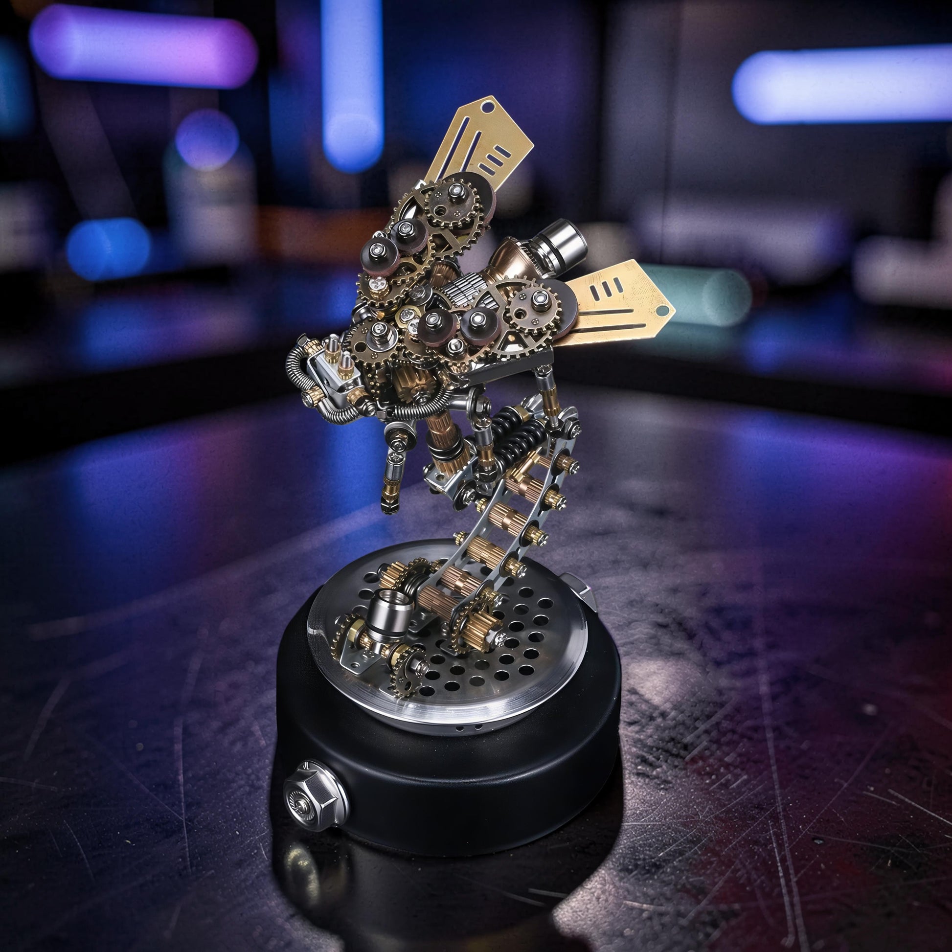 The Curious Mind Firefly 3D metal model kit with intricate gears and brass wings, displayed on a black base.