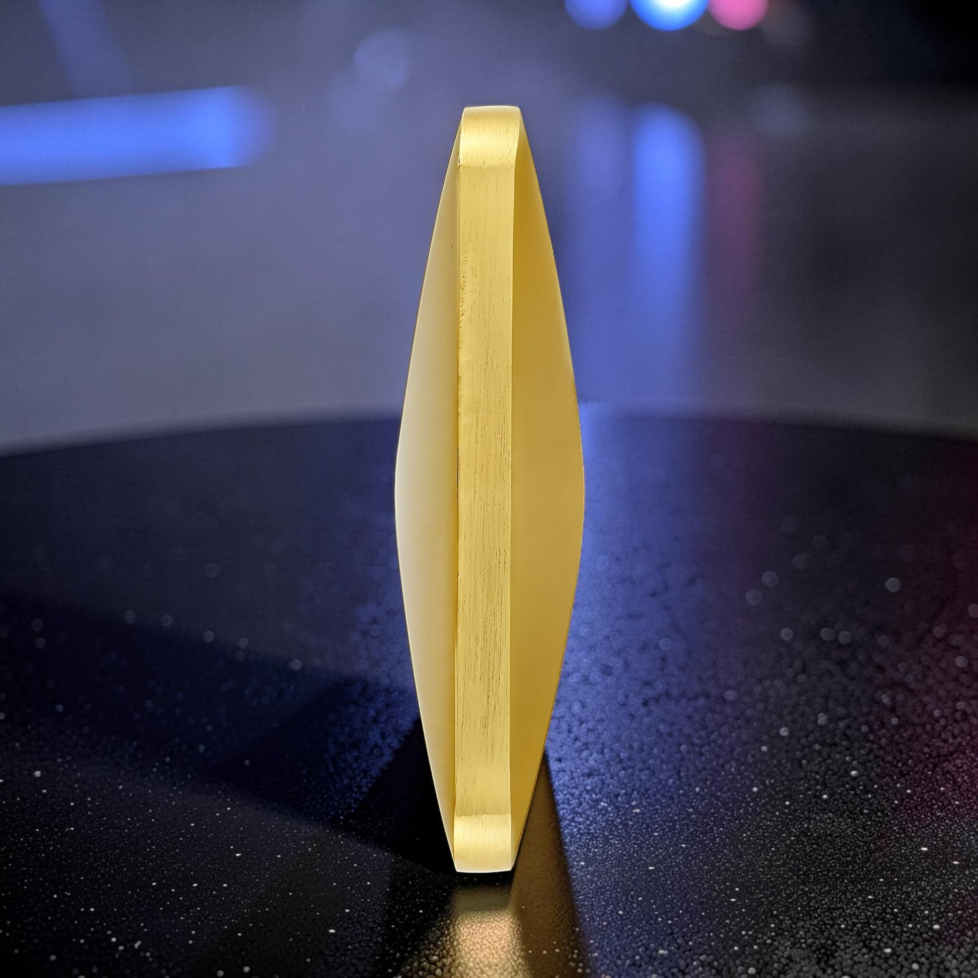 The Curious Mind Flipo Flip Square Desk Spinner, a kinetic sculpture made of brushed aluminum with a faceted design in a gold finish.