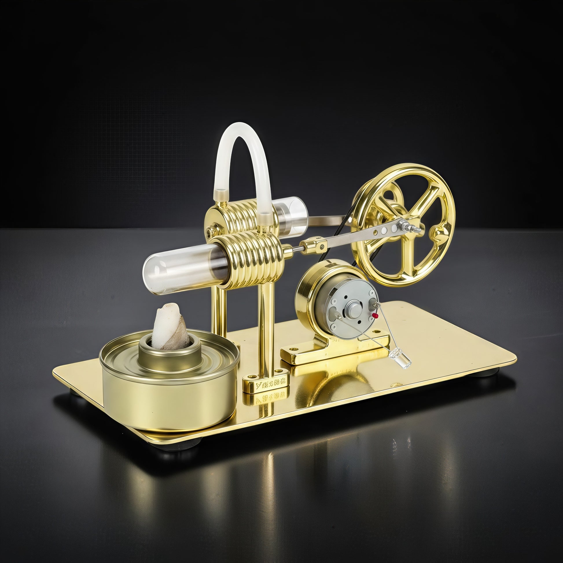 The Curious Mind Classic Stirling Engine DIY Kit, a gold metal model with glass cylinder and flywheel, on a black background.