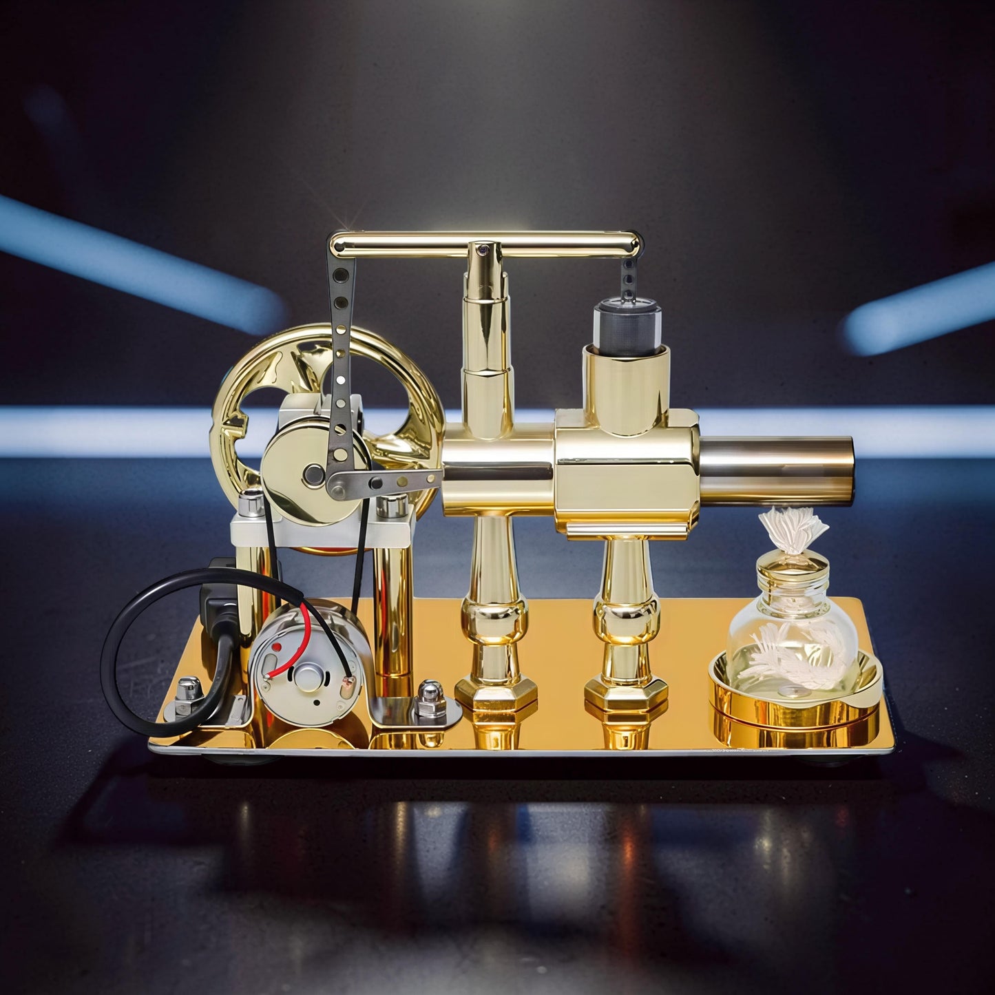 The Curious Mind Stirling Engine Model, a polished gold metal mechanical engine with a flywheel, generator, and LED light, on a display base.