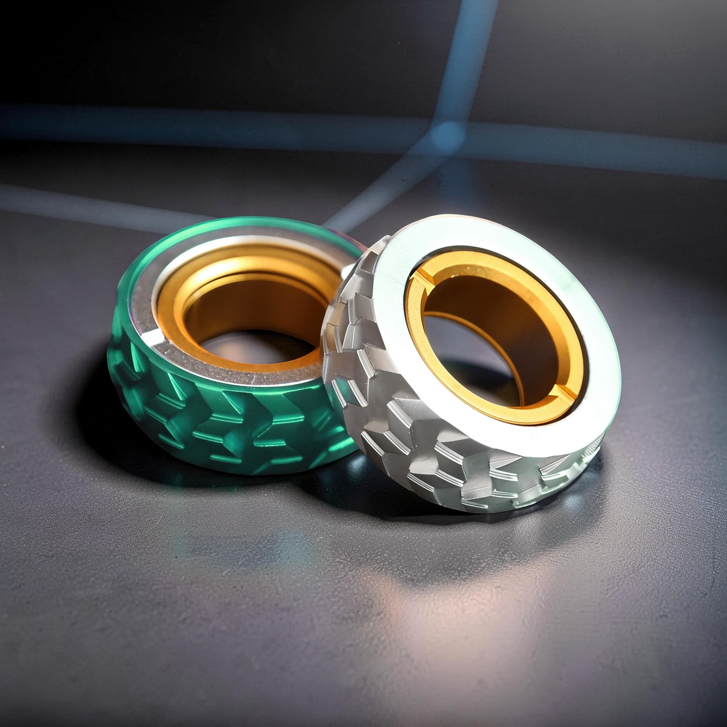 The Curious Mind Tire Haptic Ratchet Ring in silver and green metal with gold inner ring. Compact fidget toy.