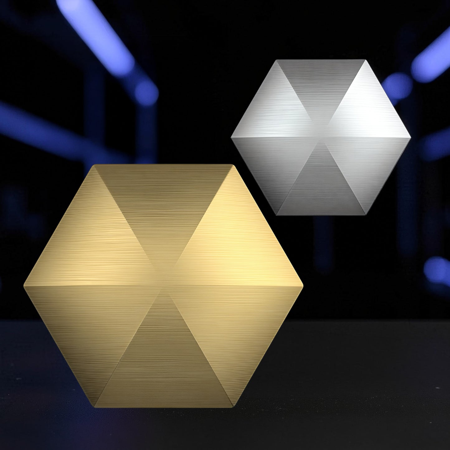 The Curious Mind Flipo Flip Hexagon Desk Spinner in gold and silver brushed metal finishes. Kinetic desk toy for focus and stress relief.