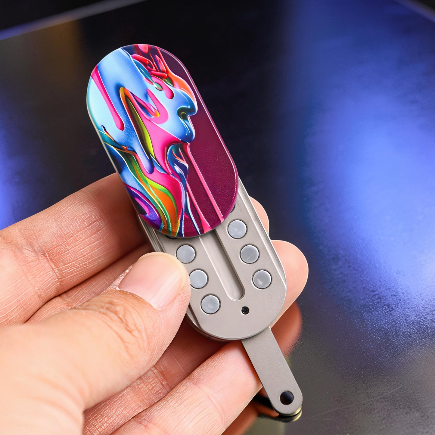 The Curious Mind Ice Cream Push Card Clicker fidget toy with abstract colorful design and metal click buttons.