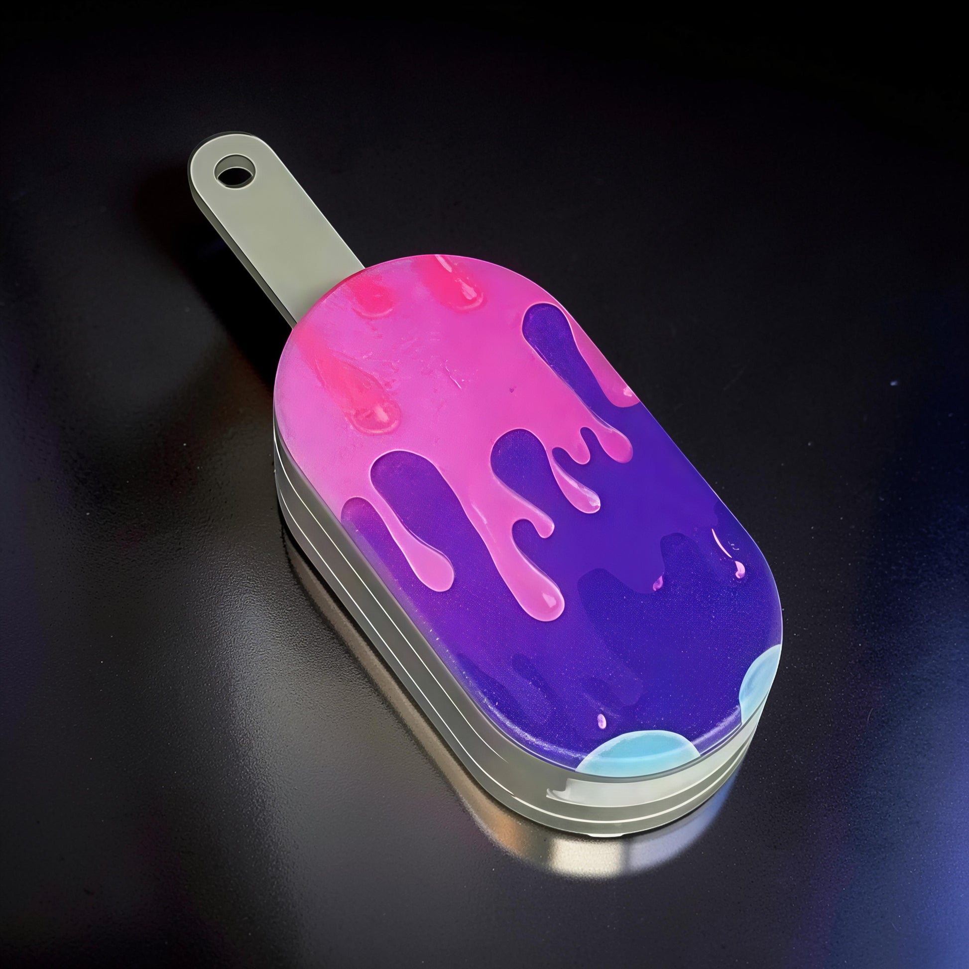 The Curious Mind Ice Cream Push Card Clicker fidget toy with pink and purple dripping design on metal casing.