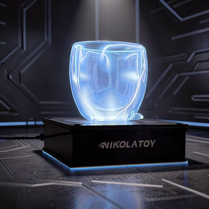 The Curious Mind Inert Gas Lightning Cup with display base, a glass cup with blue electrical currents inside, on a black illuminated base.
