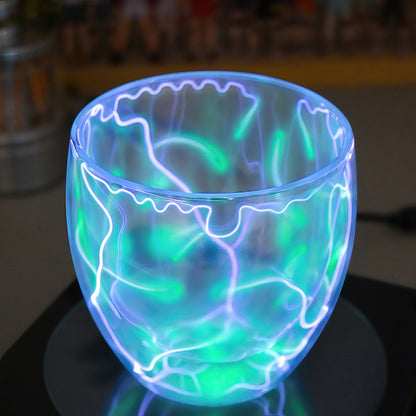 The Curious Mind Inert Gas Lightning Cup with display base, featuring swirling blue and green plasma arcs within a glass vessel.