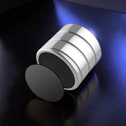 The Curious Mind Vortecon kinetic desk spinner, a premium metal desk toy with a silver finish and black accents, designed for focus and stress relief.