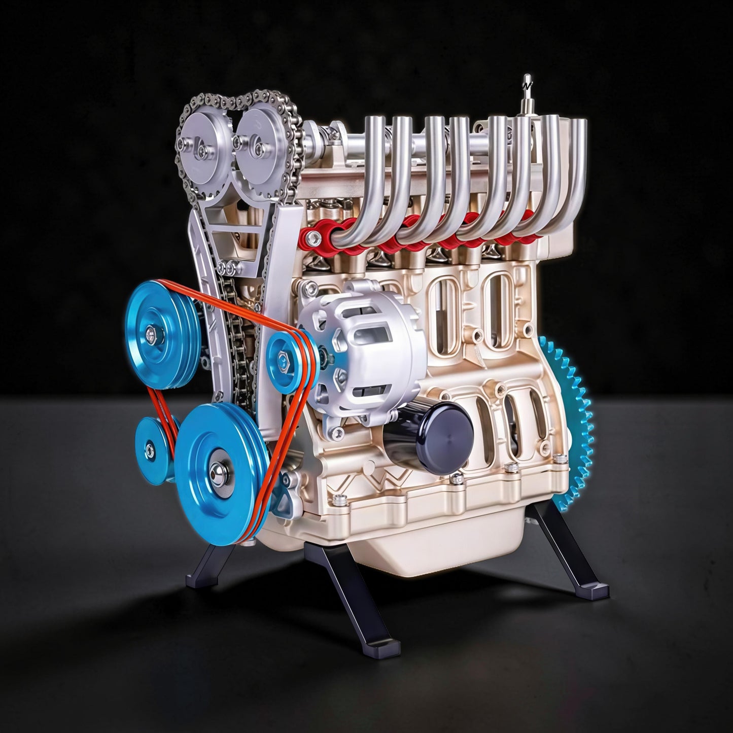 The Curious Mind L4 Four-Cylinder Engine DIY Kit, a detailed metal mechanical model with blue pulleys and orange belt.