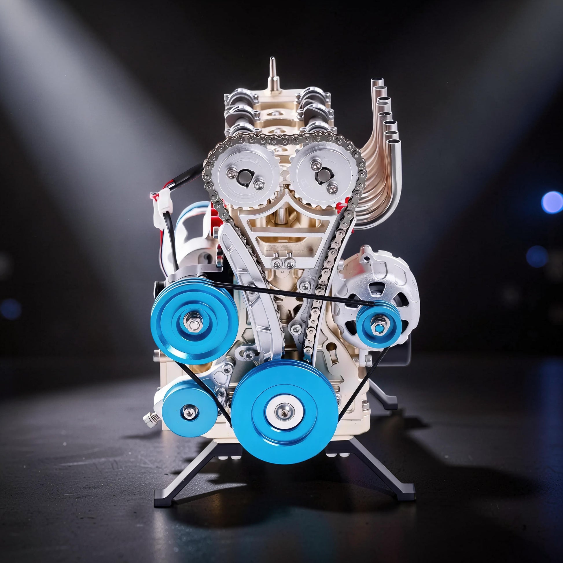 The Curious Mind L4 Four-Cylinder Engine DIY Kit, a detailed metal mechanical model with blue accents and a display stand.