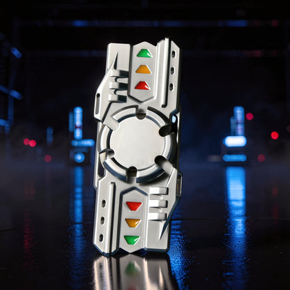 The Curious Mind Laser Cannon Glow Spinner, a futuristic metal fidget toy with red, yellow, and green accents. Balanced for smooth rotation.