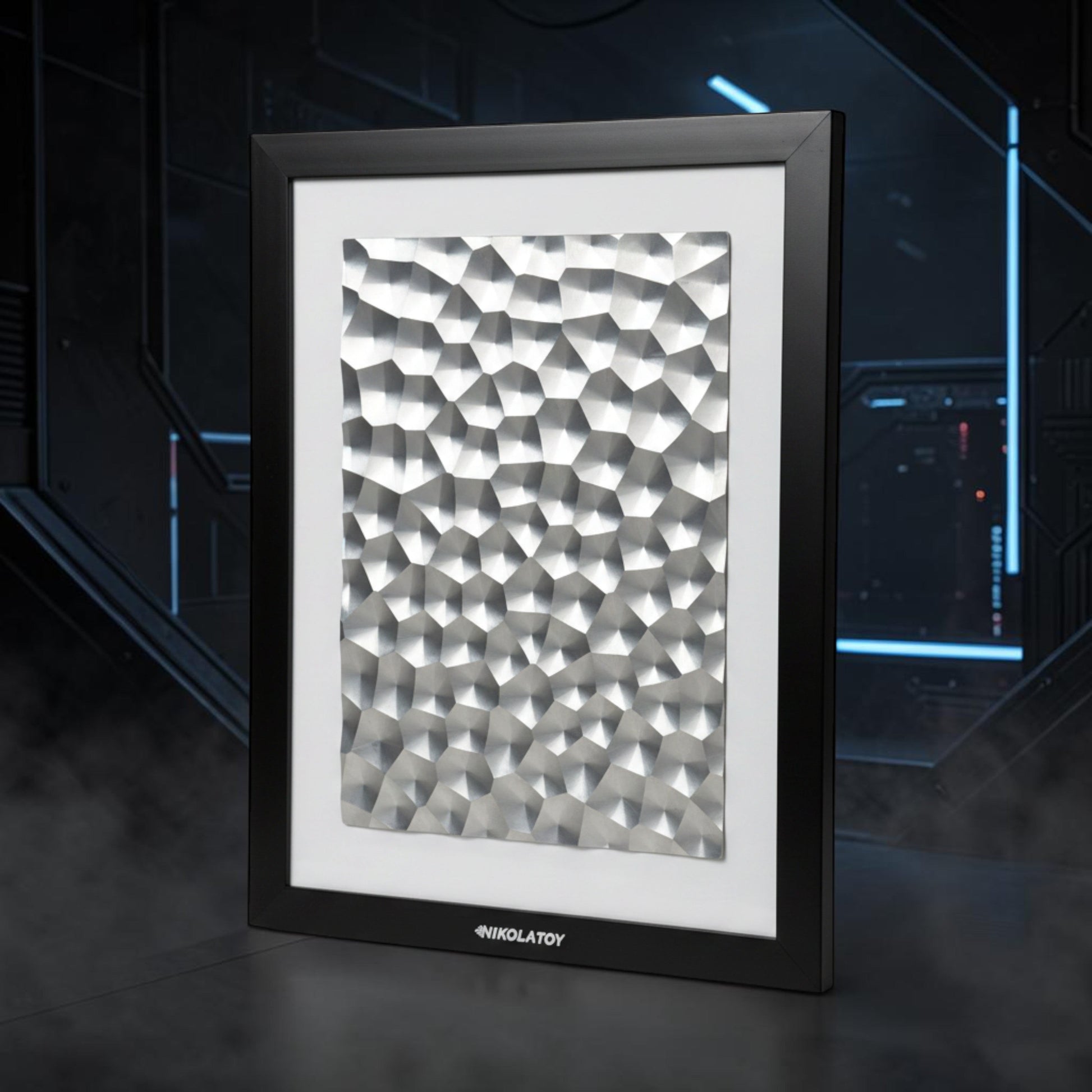 The Curious Mind Laser Light Effect Art Frame with a geometric silver metal textured panel in a black wood frame.