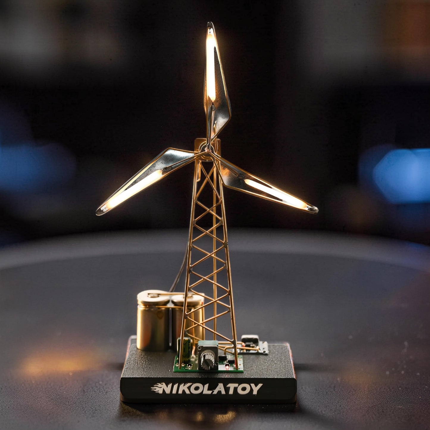 The Curious Mind LED windmill night light with gold-tone frame, black base, and glowing blades. DIY ambient desk lamp.