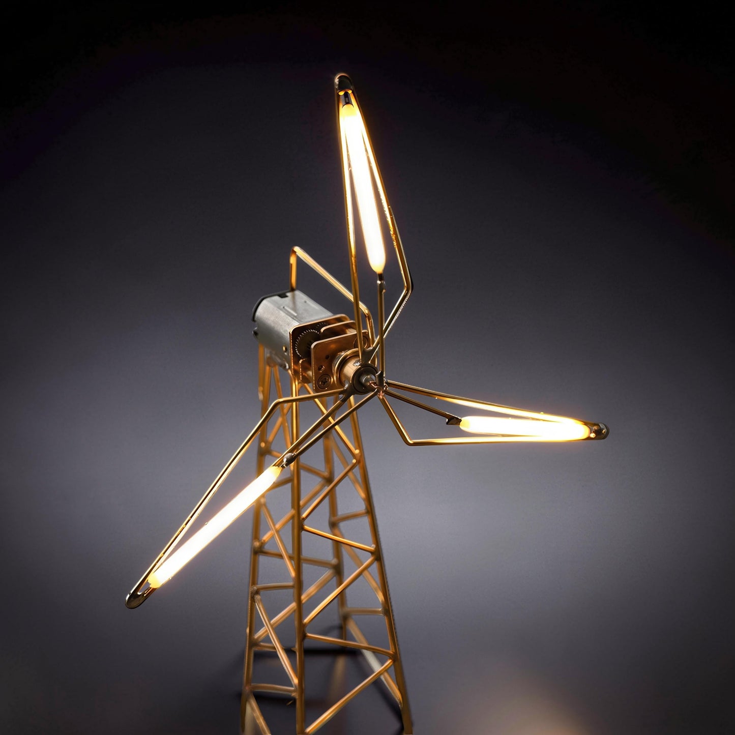 The Curious Mind LED Windmill Night Light, a DIY metal desk lamp with a gold-toned frame and three illuminated blades.