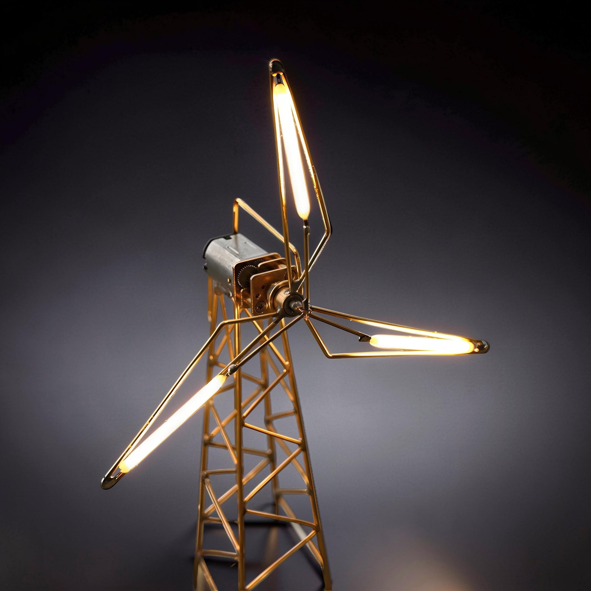 The Curious Mind LED Windmill Night Light, a DIY metal desk lamp with a gold-toned frame and three illuminated blades.