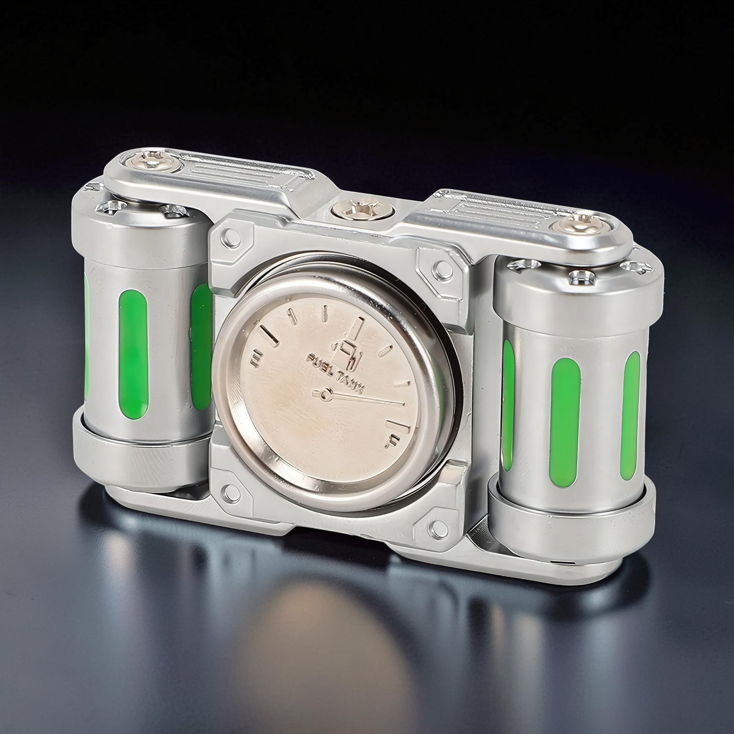 The Curious Mind Luminous Tank Metal Spinner with green glowing accents and a fuel gauge design. Silver metal.