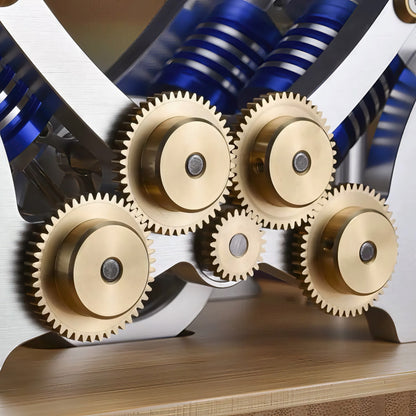 The Curious Mind M20 Stirling Engine model with brass gears and blue cylinders, precision mechanical display.