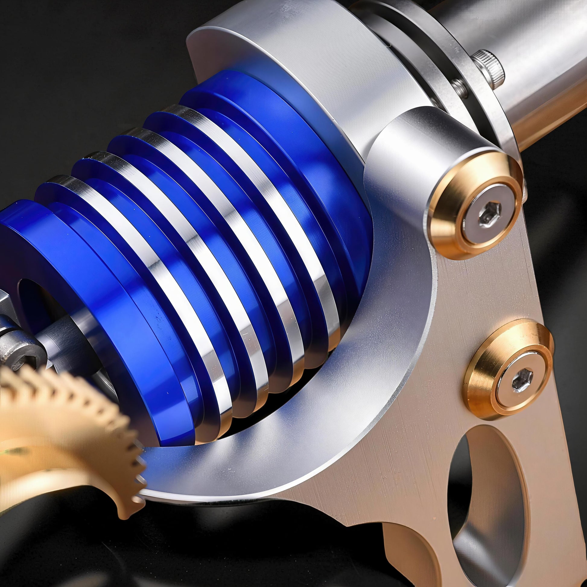 The Curious Mind M20 Stirling engine model with blue and silver fins, brass gear, and metal construction.
