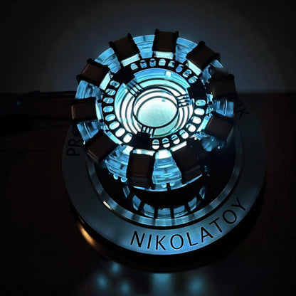 The Curious Mind Maglev Iron Man Ark Reactor Flagship HUD Edition, a metal desk object with blue glowing lights and a circular base.