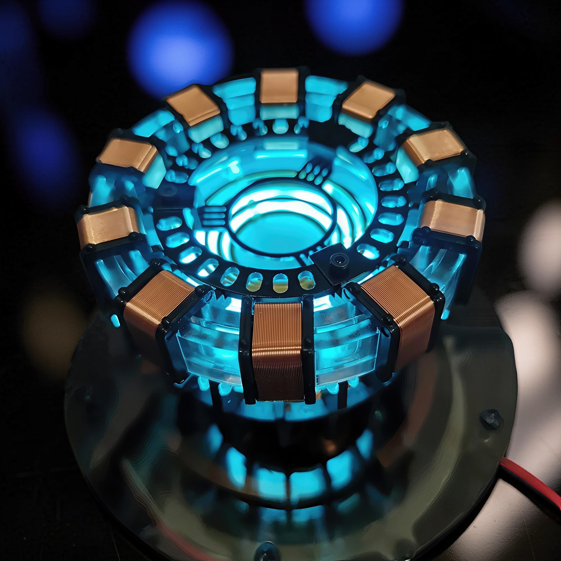 The Curious Mind Maglev Iron Man Ark Reactor Flagship HUD Edition, a metal desk object with glowing blue lights and copper coils.