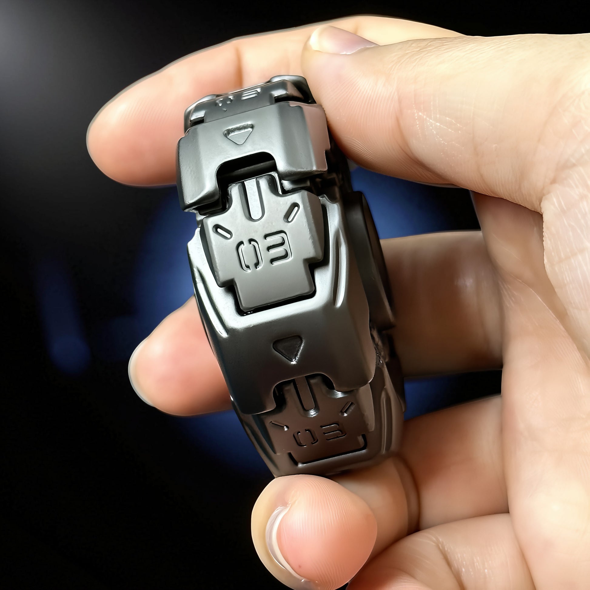 The Curious Mind Open Armour Magnetic Spinner fidget toy in dark grey metal with magnetic accents and '03' markings.