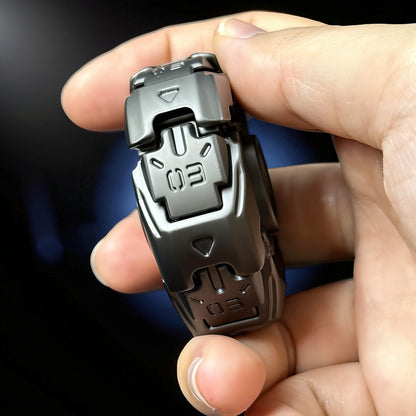 The Curious Mind Open Armour Magnetic Spinner fidget toy in dark grey metal with magnetic accents and '03' markings.