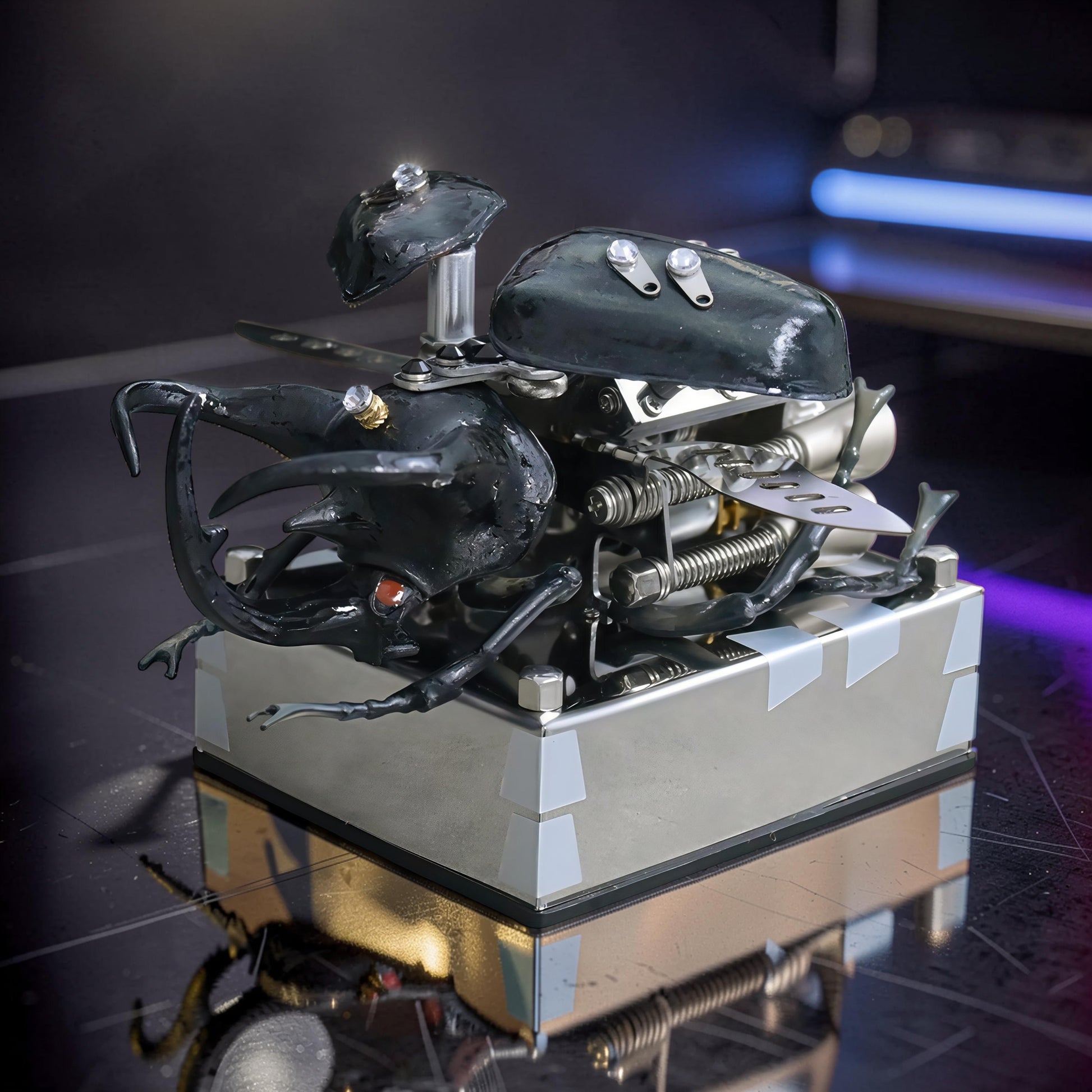 The Curious Mind Mechanical V8 Beetle Display Model, a black alloy metal and resin sculpture with intricate mechanical details and gem accents.