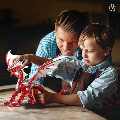 The Curious Mind Pterosaur DIY Kit: father and son build a red and white mechanical dragon model.