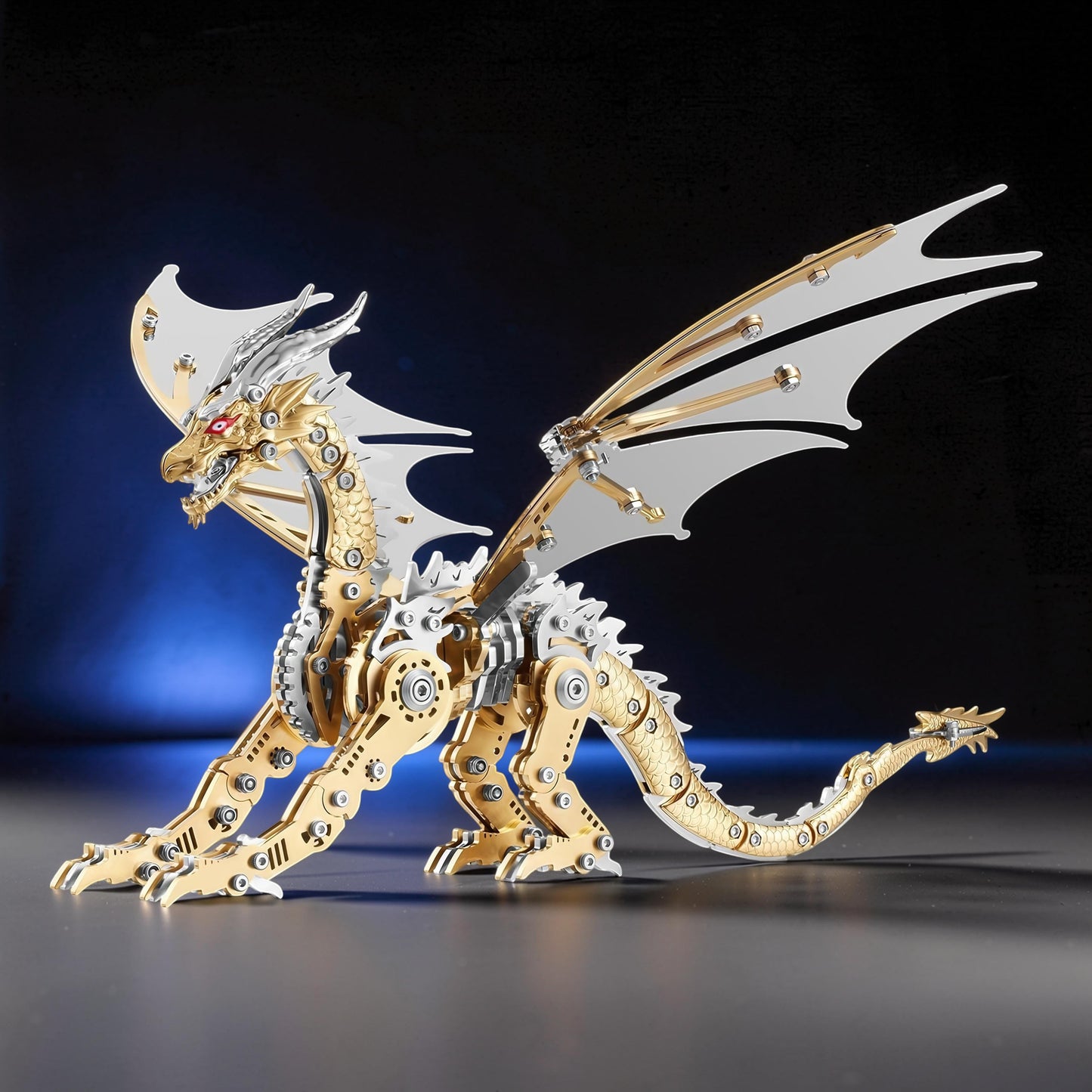 The Curious Mind Pterosaur DIY Kit: a gold and silver mechanical dragon model with white wings and red eyes.