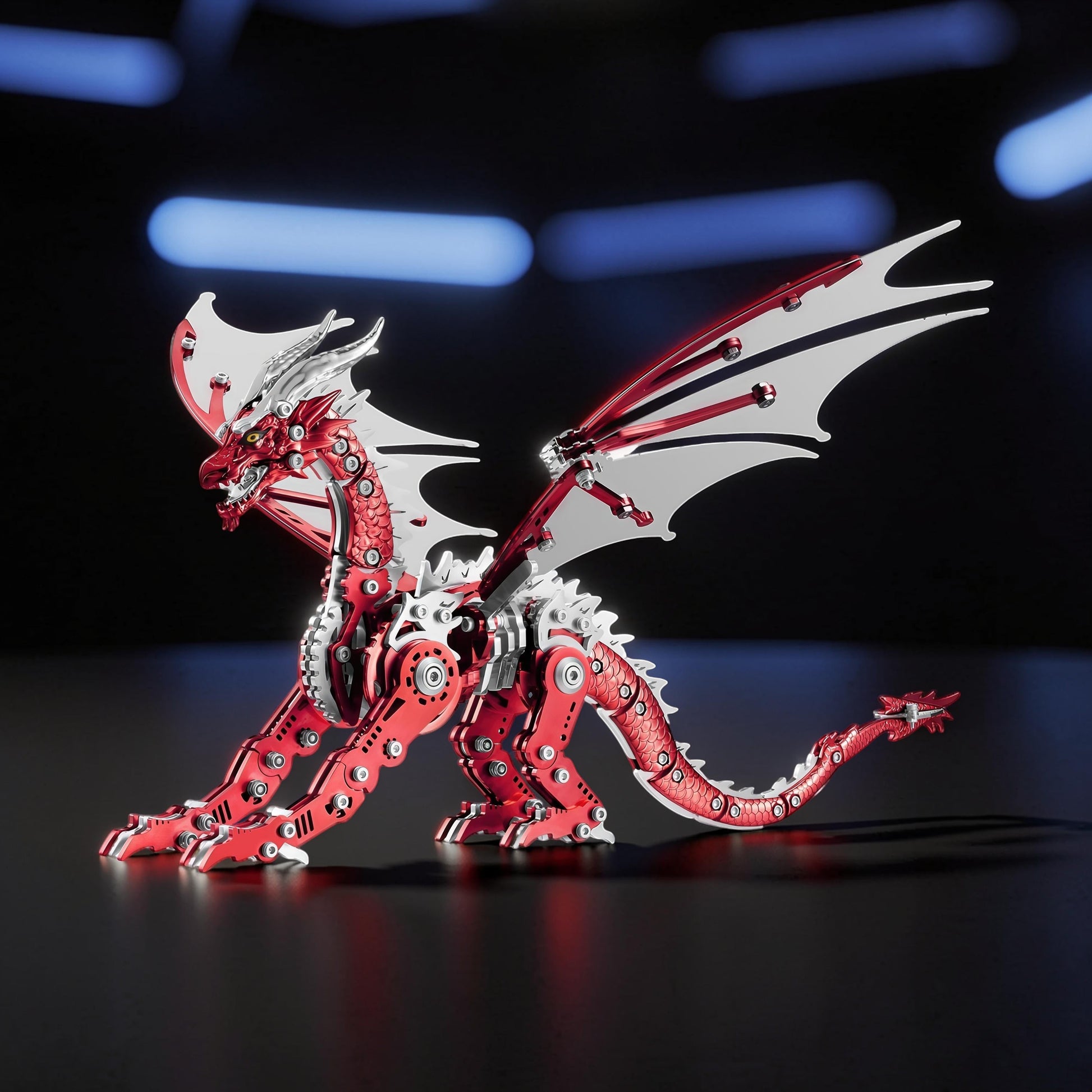 The Curious Mind Pterosaur DIY Kit: a detailed red and silver metal mechanical dragon model with intricate gears and articulated wings, displayed on a dark surface with blue bokeh lighting.