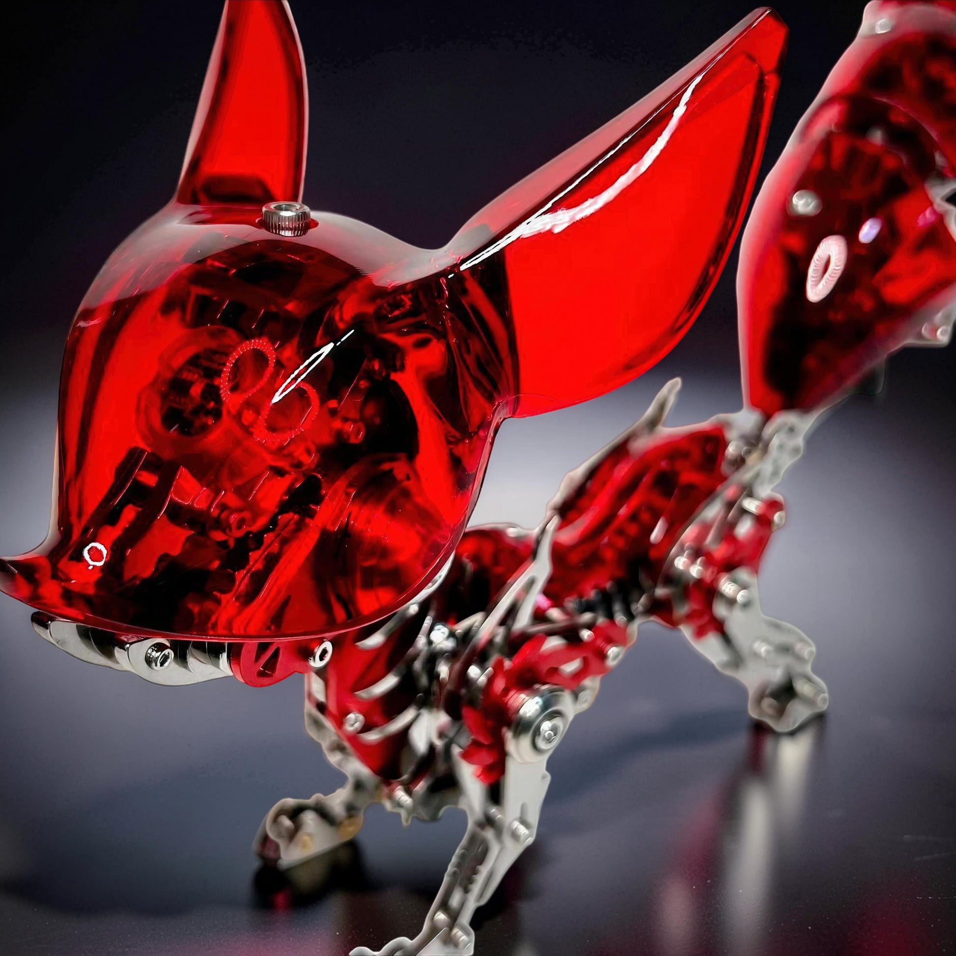 The Curious Mind Mechanical Fox 3D metal model kit with translucent red accents and metallic silver frame. Intricate mechanical details visible.