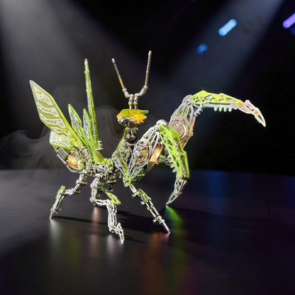 The Curious Mind Mechanical Mantis 3D metal model kit with intricate green and silver metallic details and translucent wings.