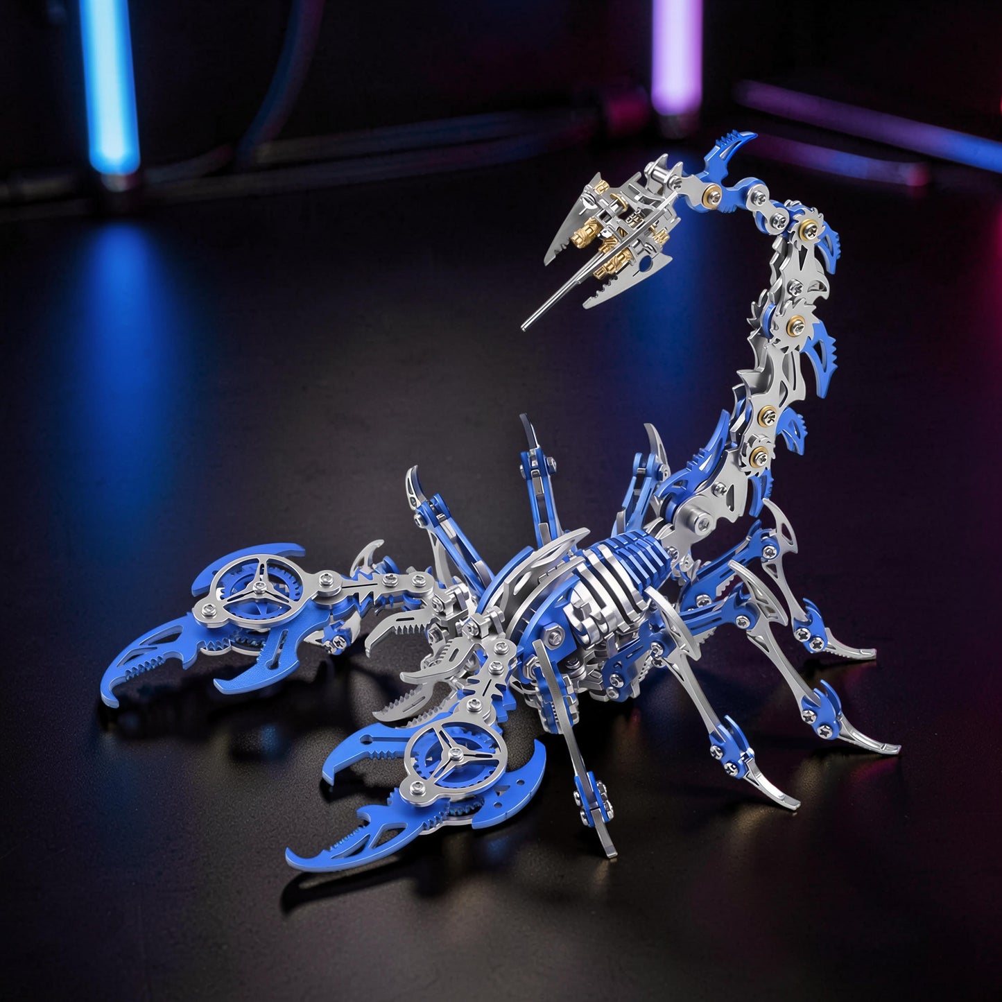 The Curious Mind Mechanical Scorpion 3D metal model kit with blue and silver metal pieces, intricate gears, and articulated tail.